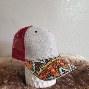Ball cap with hand-sewn leather tribal patch on brim